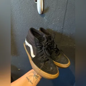 Vans Black and White High-Top Sneakers with Signature Stripe